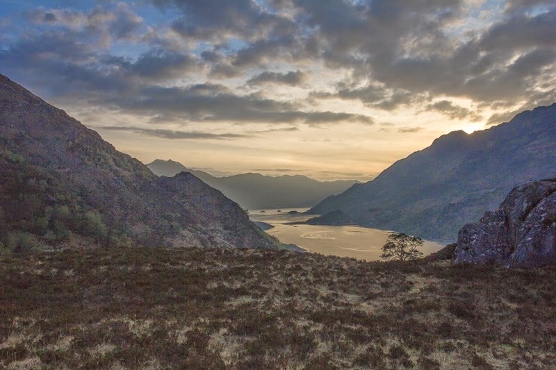 Loch Hourn im sanften Abendlicht umgeben von Bergen in Schottland